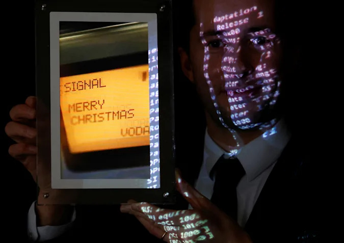 Aguttes auction house head of development Maximilien Aguttes holds a non-fungible token (NFT), replica of the original communication protocol that transmitted the first SMS text message ever sent, before its auction by Britain's Vodafone, in Neuilly-sur-Seine, near Paris, France, December 20, 2021. REUTERS/Christian Hartmann